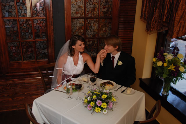 Wedding couple sitting at dinner table