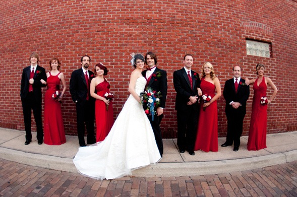 Wedding party in front of brick wall