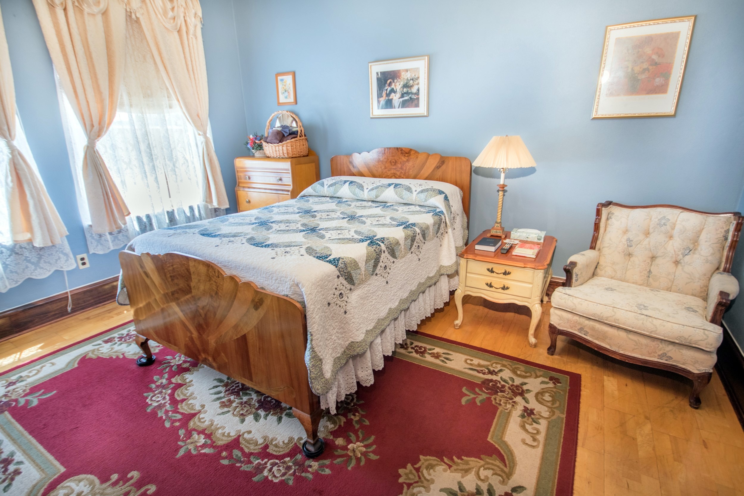 Hotel room with hardwood floors and blue walls